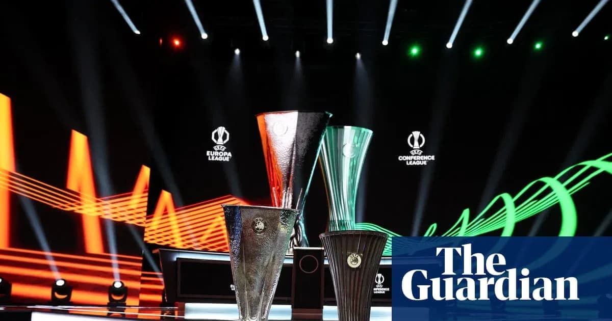 Three UEFA trophies on stage with lighting effects Three UEFA trophies on stage with lighting effects