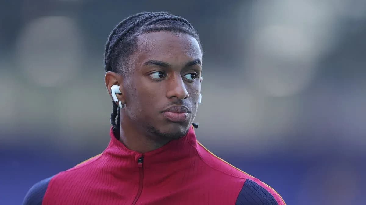 Player wearing earbuds during warm-up session Player wearing earbuds during warm-up session