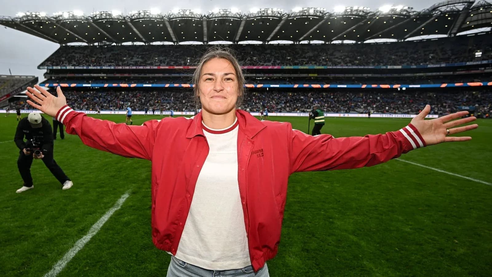 Woman in red jacket celebrating on the pitch Woman in red jacket celebrating on the pitch