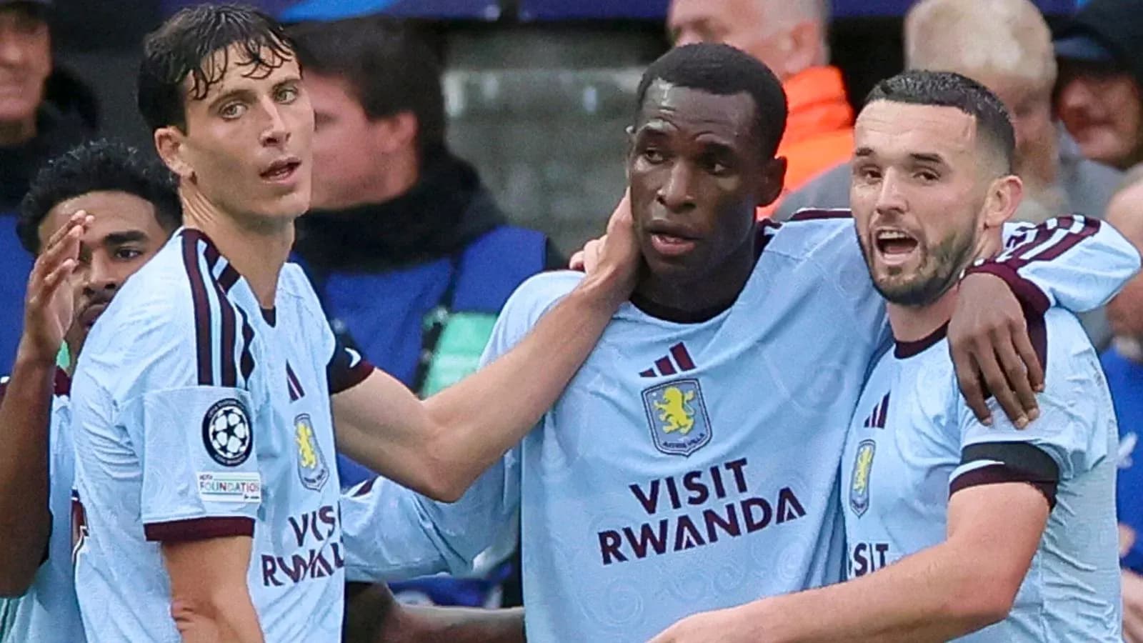 Three Aston Villa players celebrating a goal Three Aston Villa players celebrating a goal