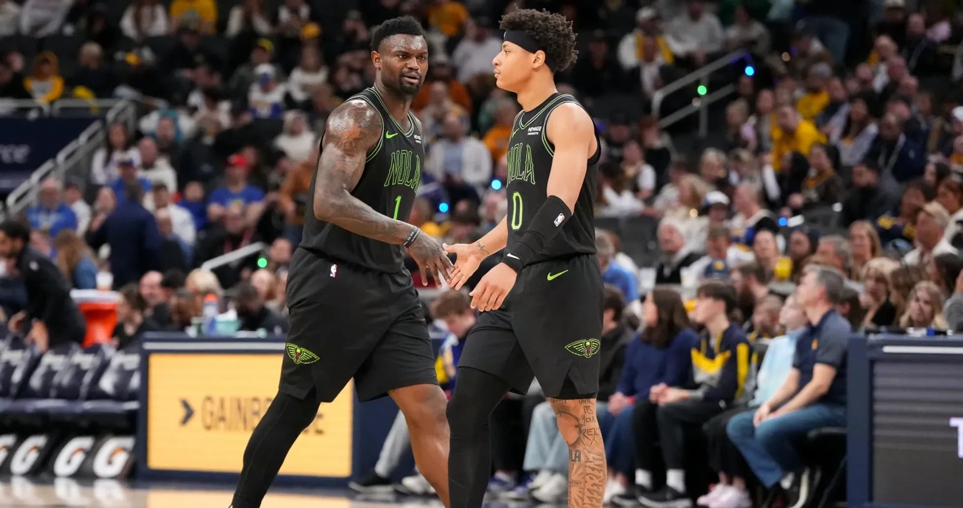 Two basketball players exchanging a handshake during game Two basketball players exchanging a handshake during game
