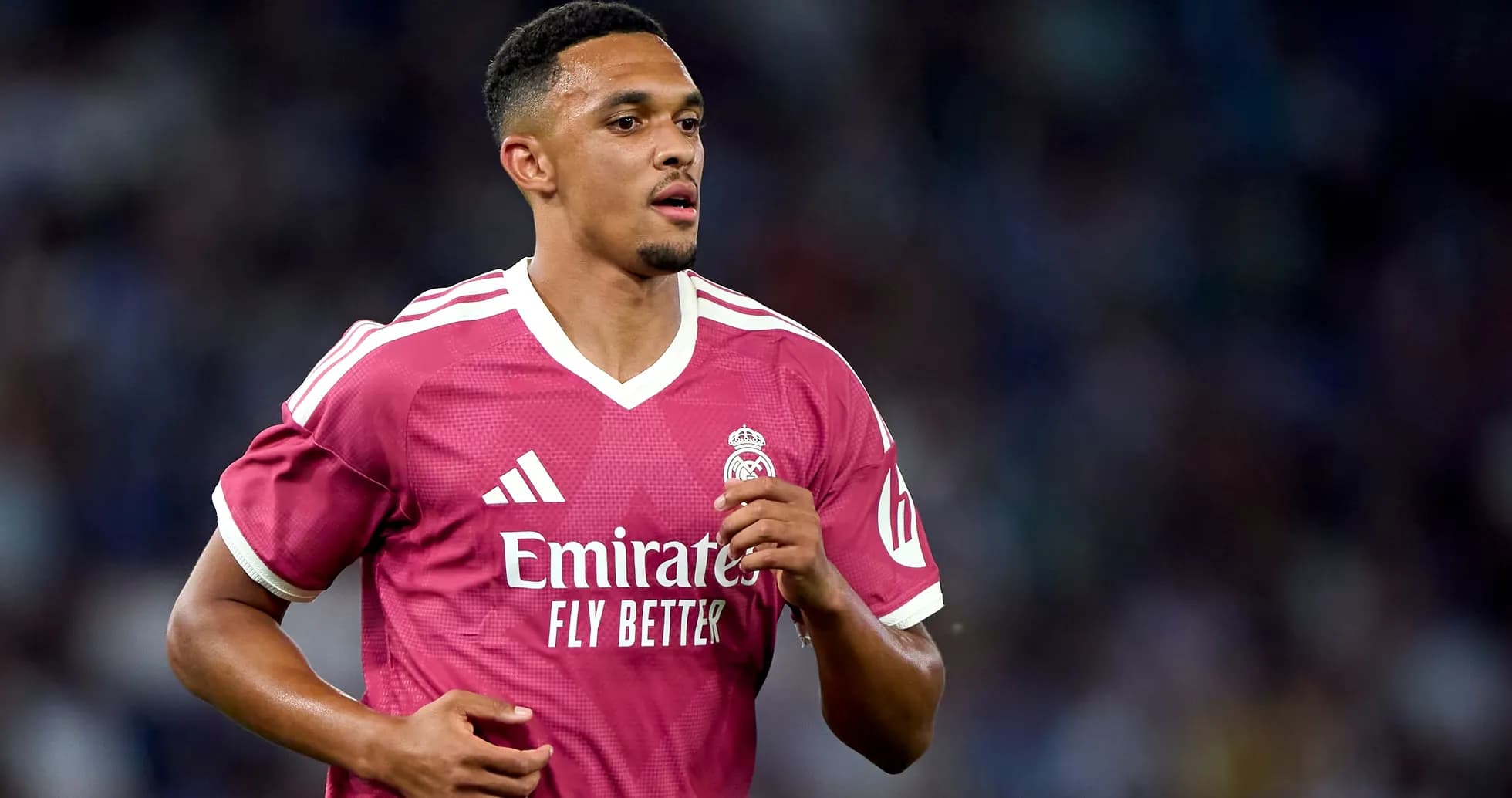 Player running in pink Real Madrid jersey on field Player running in pink Real Madrid jersey on field