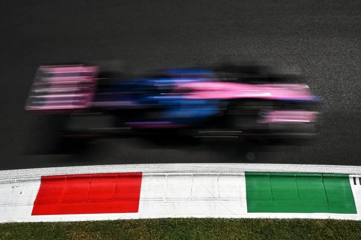 Formula 1 car speeding past colorful track markings Formula 1 car speeding past colorful track markings