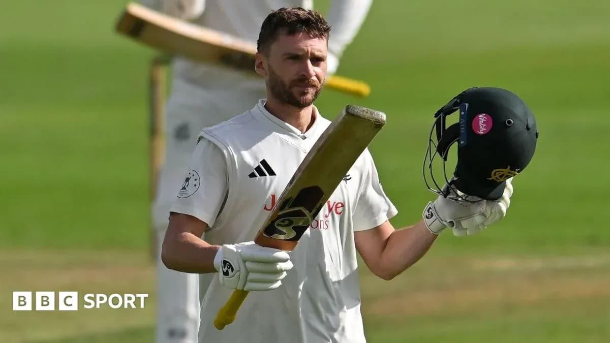 Batsman raising bat and helmet on cricket field Batsman raising bat and helmet on cricket field