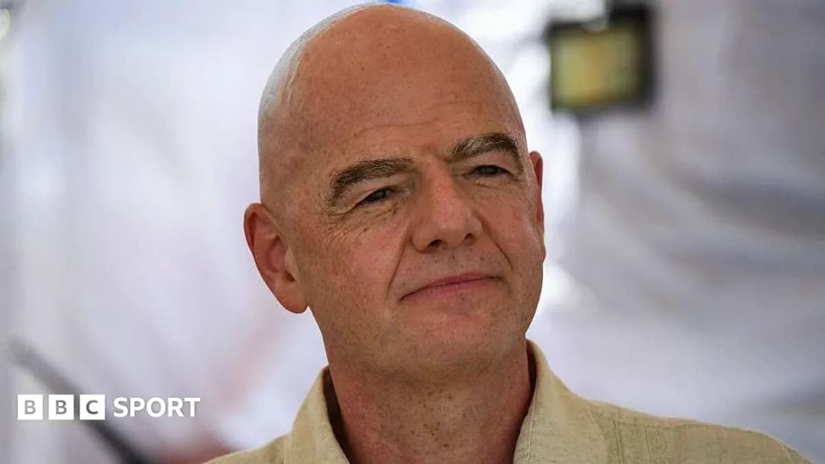 Person with shaved head speaking at an event Person with shaved head speaking at an event