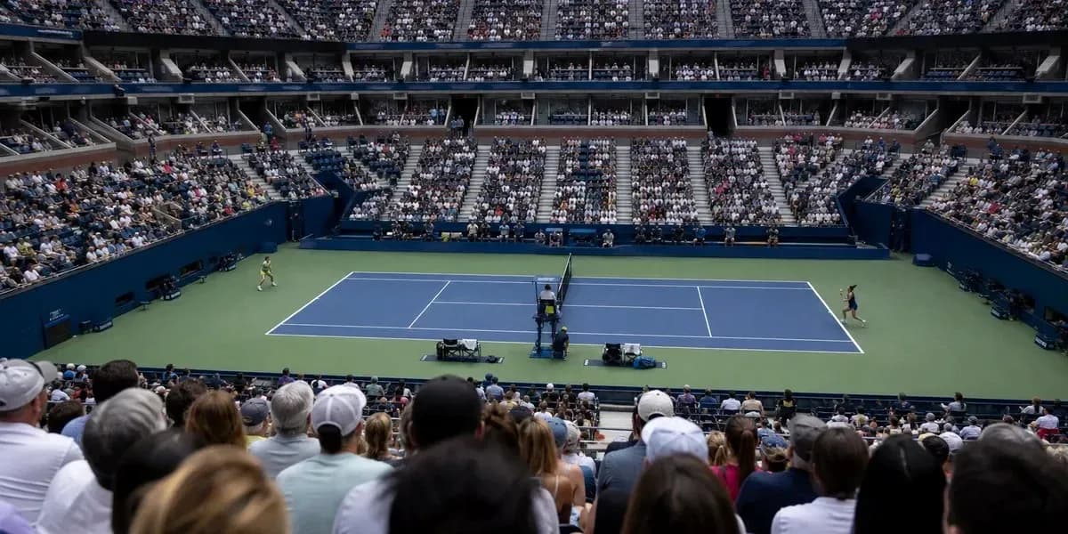 Tennis match in stadium with large crowd Tennis match in stadium with large crowd