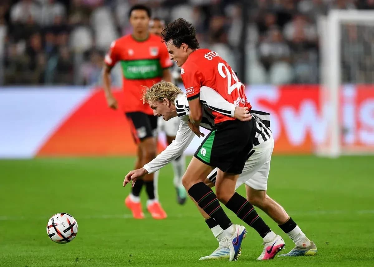 Two players competing for the ball on field Two players competing for the ball on field