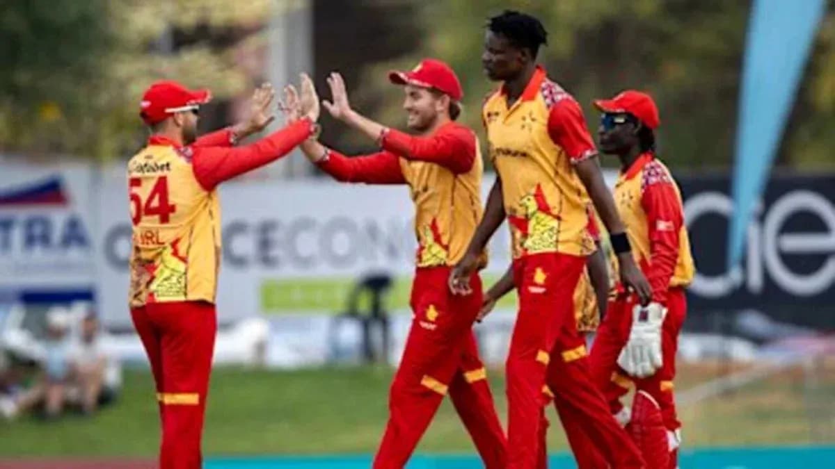 Cricket team celebrating a wicket on the field Cricket team celebrating a wicket on the field