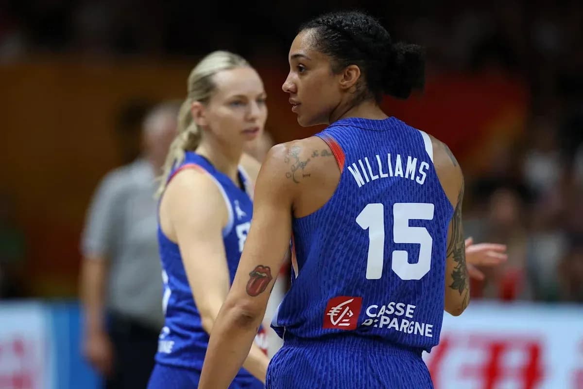 Two basketball players in blue jerseys during game Two basketball players in blue jerseys during game