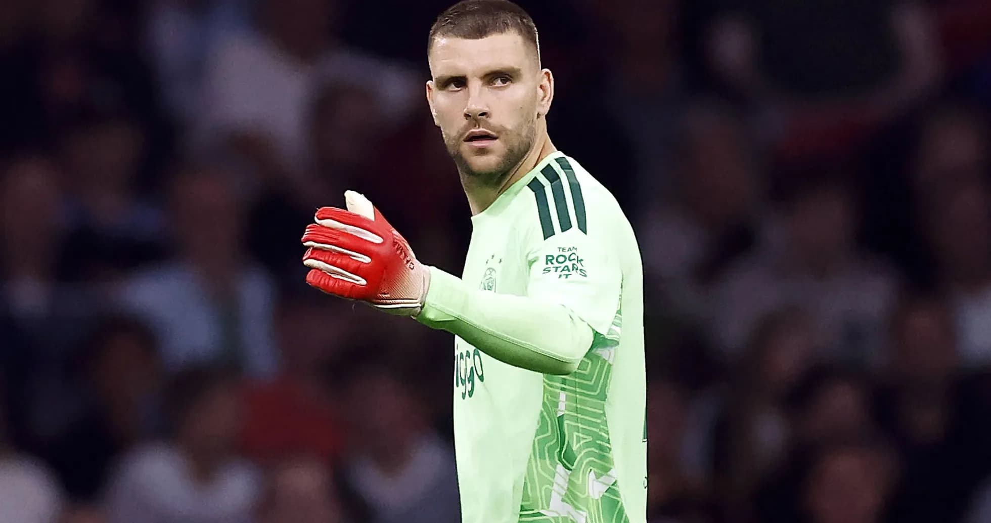 Goalkeeper signaling during a match in green kit Goalkeeper signaling during a match in green kit