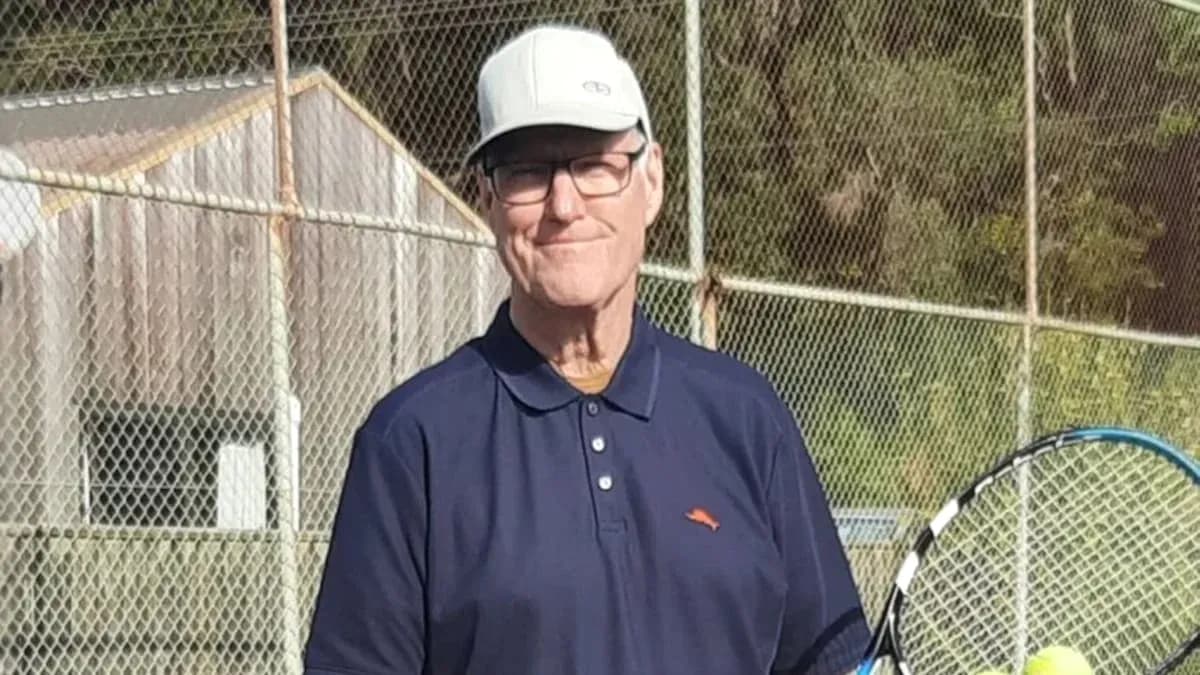 Man holding a tennis racket on court Man holding a tennis racket on court