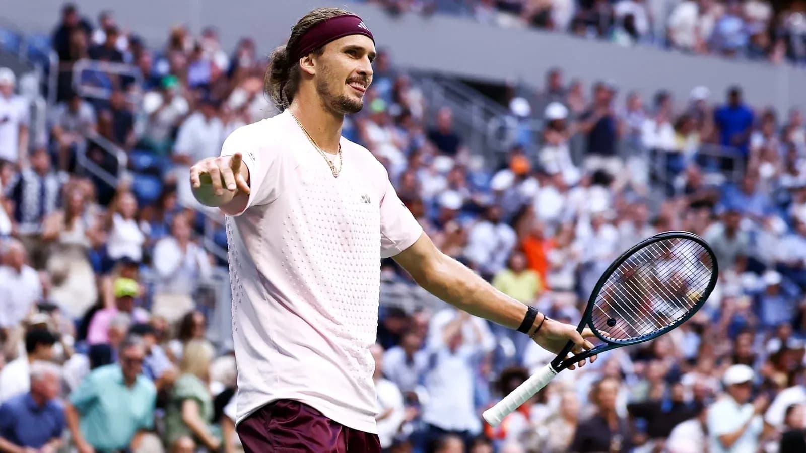 Tennis player gesturing during match with spectators in background Tennis player gesturing during match with spectators in background