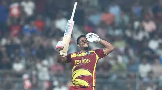 Cricketer celebrating with bat during match Cricketer celebrating with bat during match