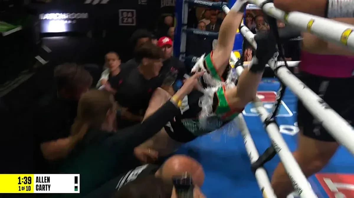 Boxer falling out of the ring during match Boxer falling out of the ring during match