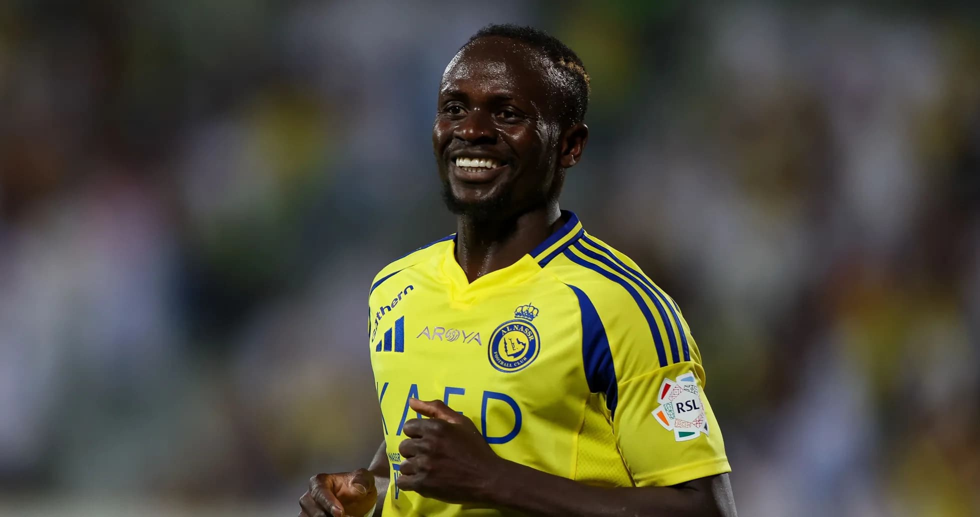Player smiling in yellow team jersey during match Player smiling in yellow team jersey during match