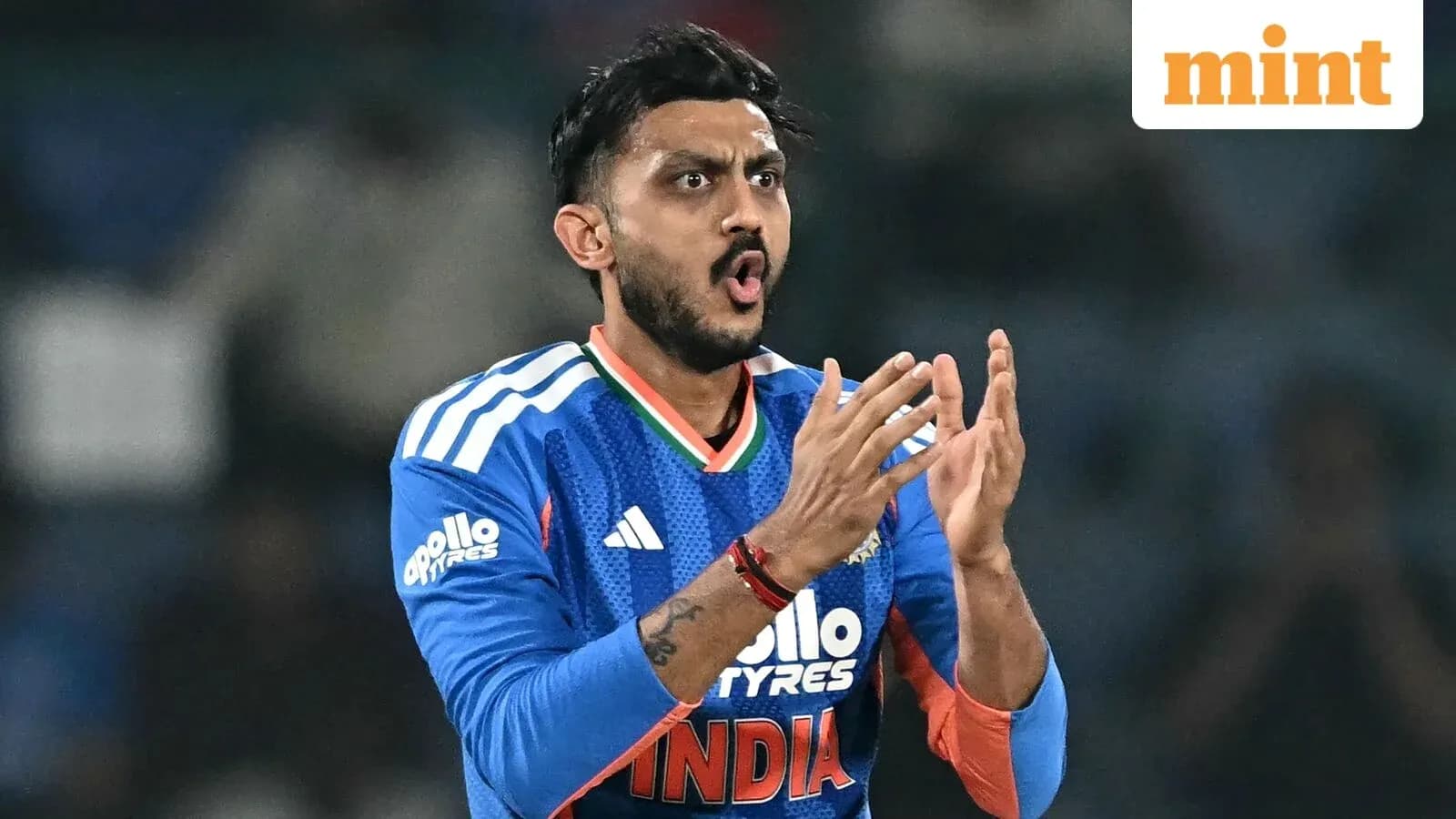 Cricketer in blue jersey clapping during match Cricketer in blue jersey clapping during match