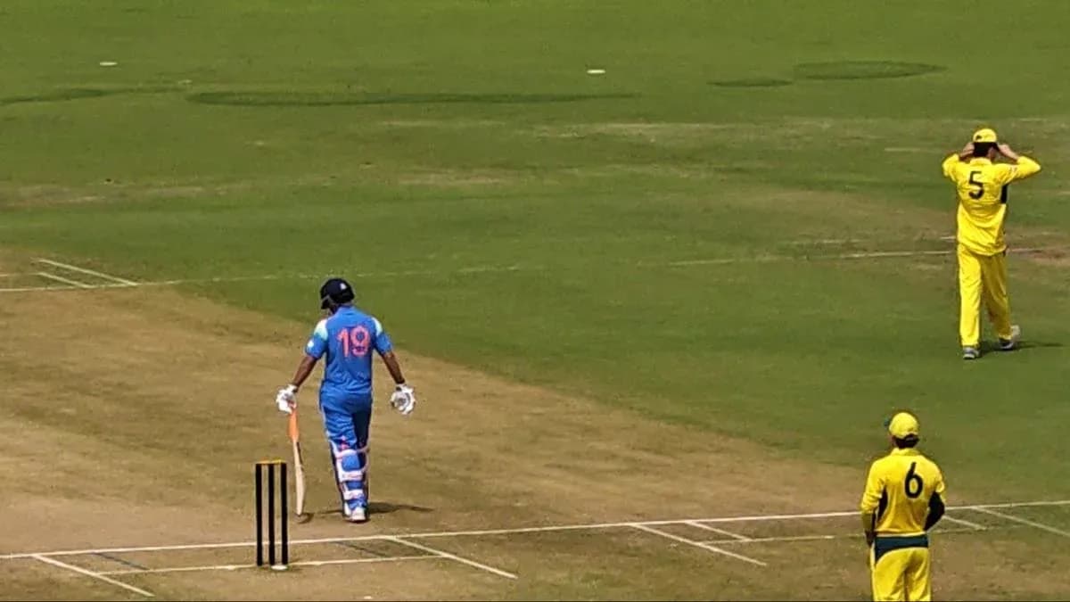 Batsman in blue uniform walking towards crease Batsman in blue uniform walking towards crease