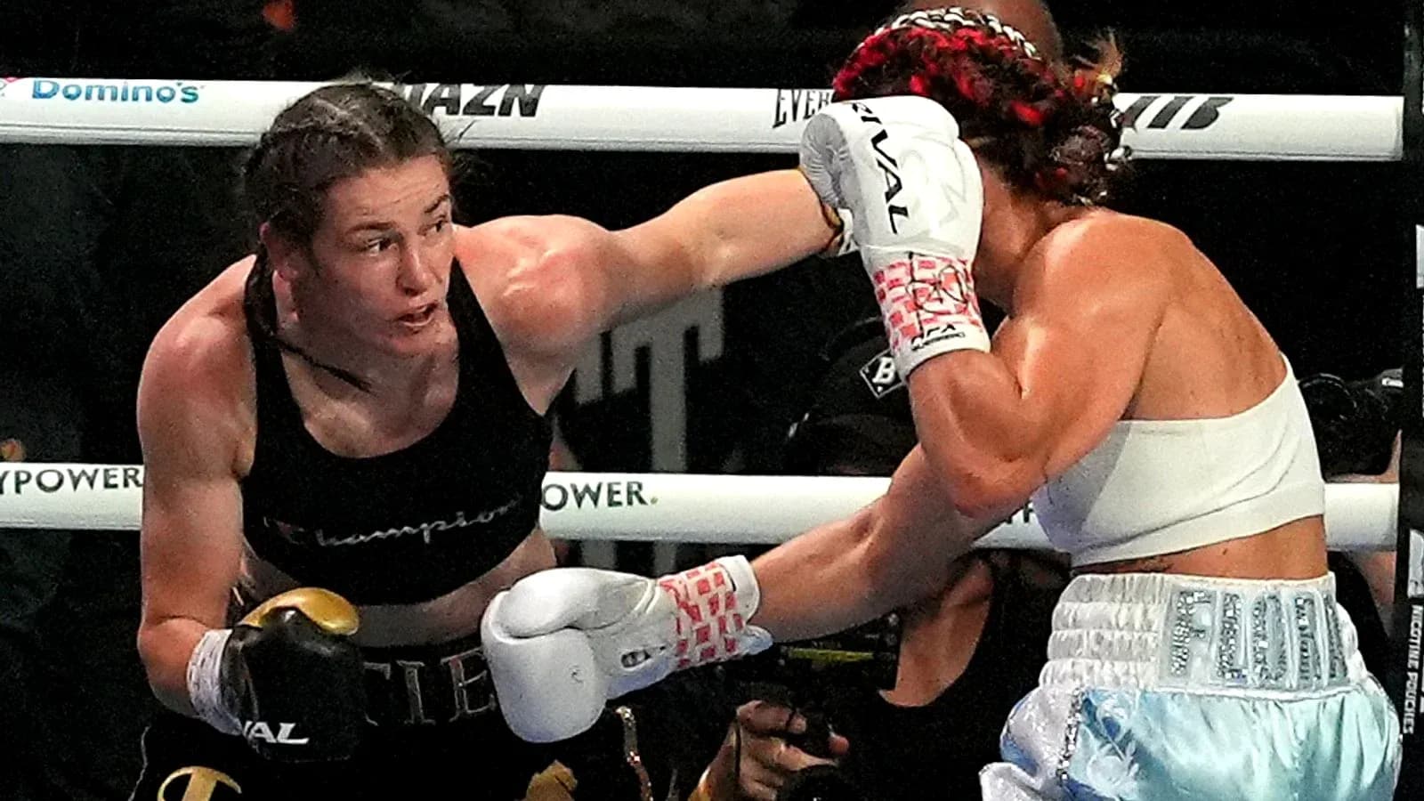 Boxers exchanging punches in a boxing match Boxers exchanging punches in a boxing match