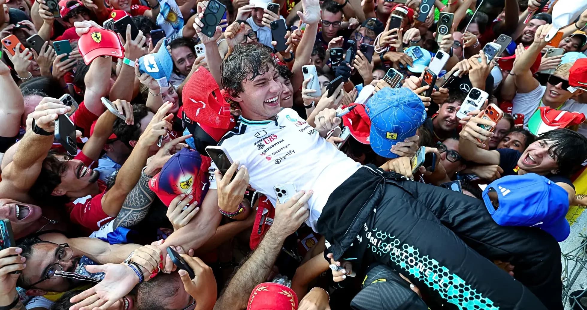 Driver celebrating with fans after race victory Driver celebrating with fans after race victory