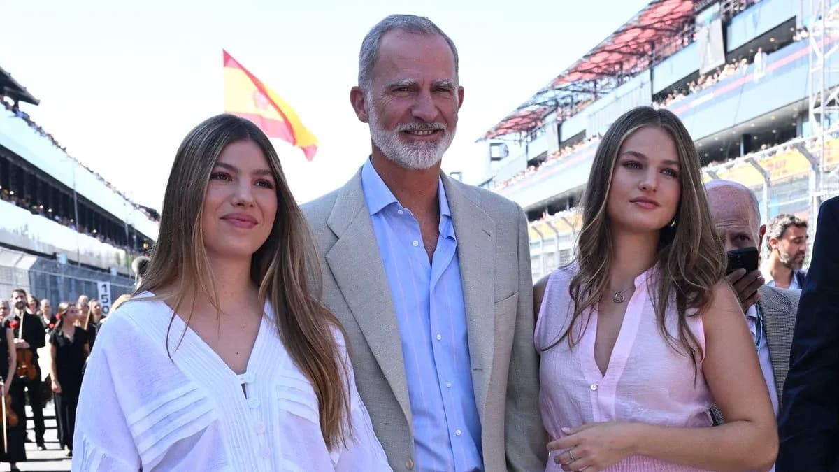 Three people posing at a motorsport event Three people posing at a motorsport event