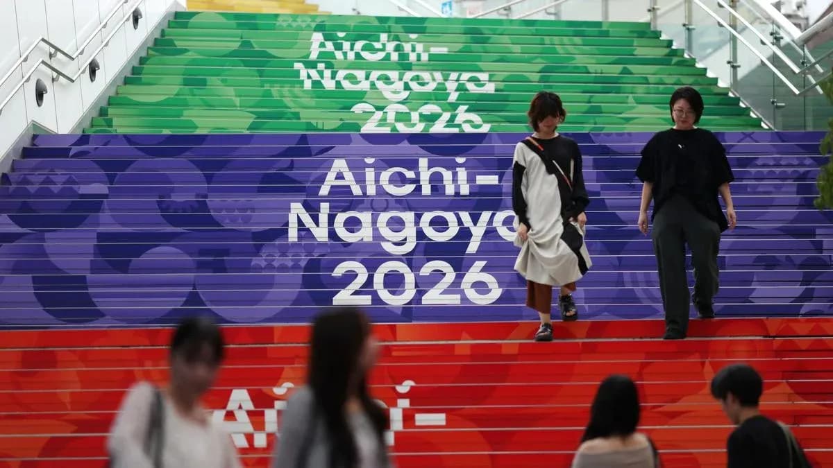 People walking down colorful stairs labeled Aichi-Nagoya 2026 People walking down colorful stairs labeled Aichi-Nagoya 2026