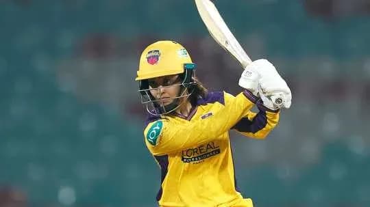 Cricketer batting in yellow team uniform Cricketer batting in yellow team uniform