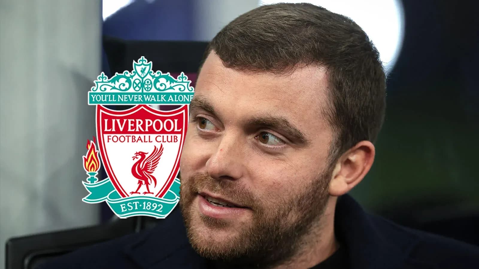 Person speaking with Liverpool FC logo in background Person speaking with Liverpool FC logo in background