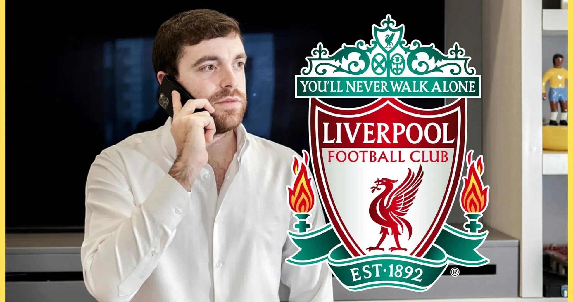 Man on phone with Liverpool FC logo in background Man on phone with Liverpool FC logo in background
