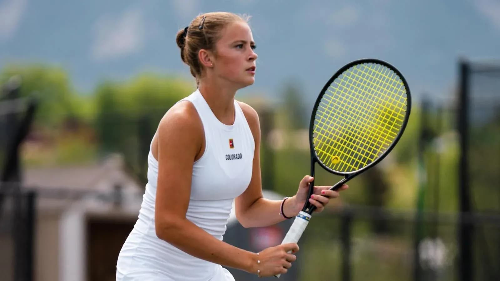 Female tennis player preparing to serve on court Female tennis player preparing to serve on court