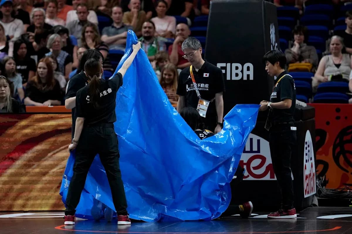 Staff preparing to cover the court with tarp Staff preparing to cover the court with tarp