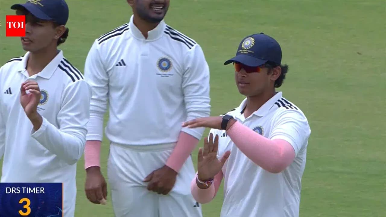 Cricket players discussing strategy on field Cricket players discussing strategy on field