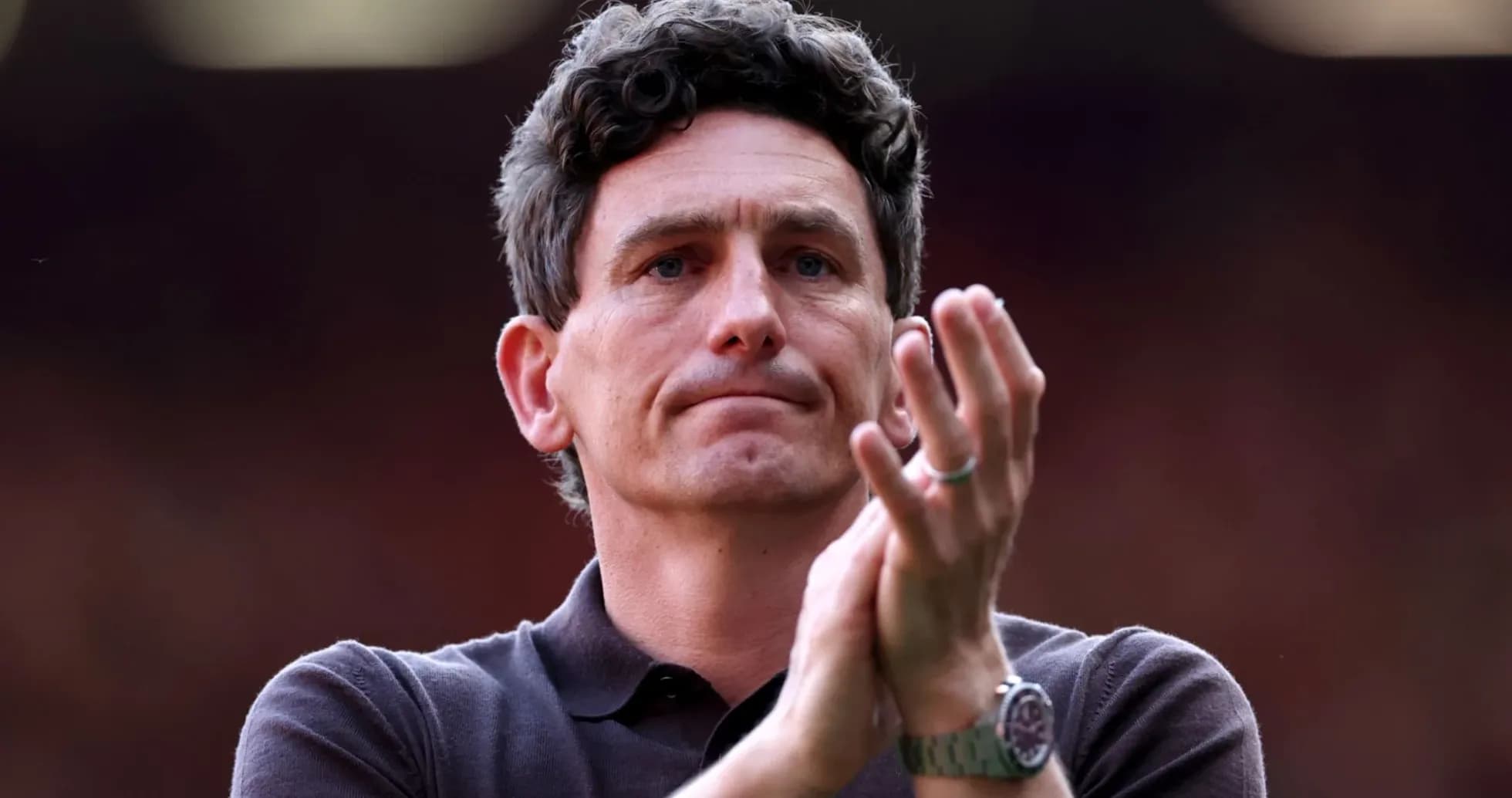 Man applauding in a sports venue Man applauding in a sports venue