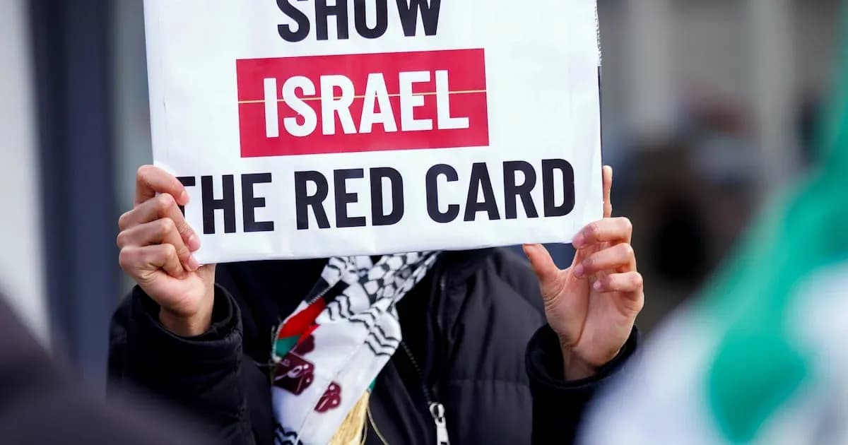 Protester holding sign reading 'Show Israel the Red Card' Protester holding sign reading 'Show Israel the Red Card'