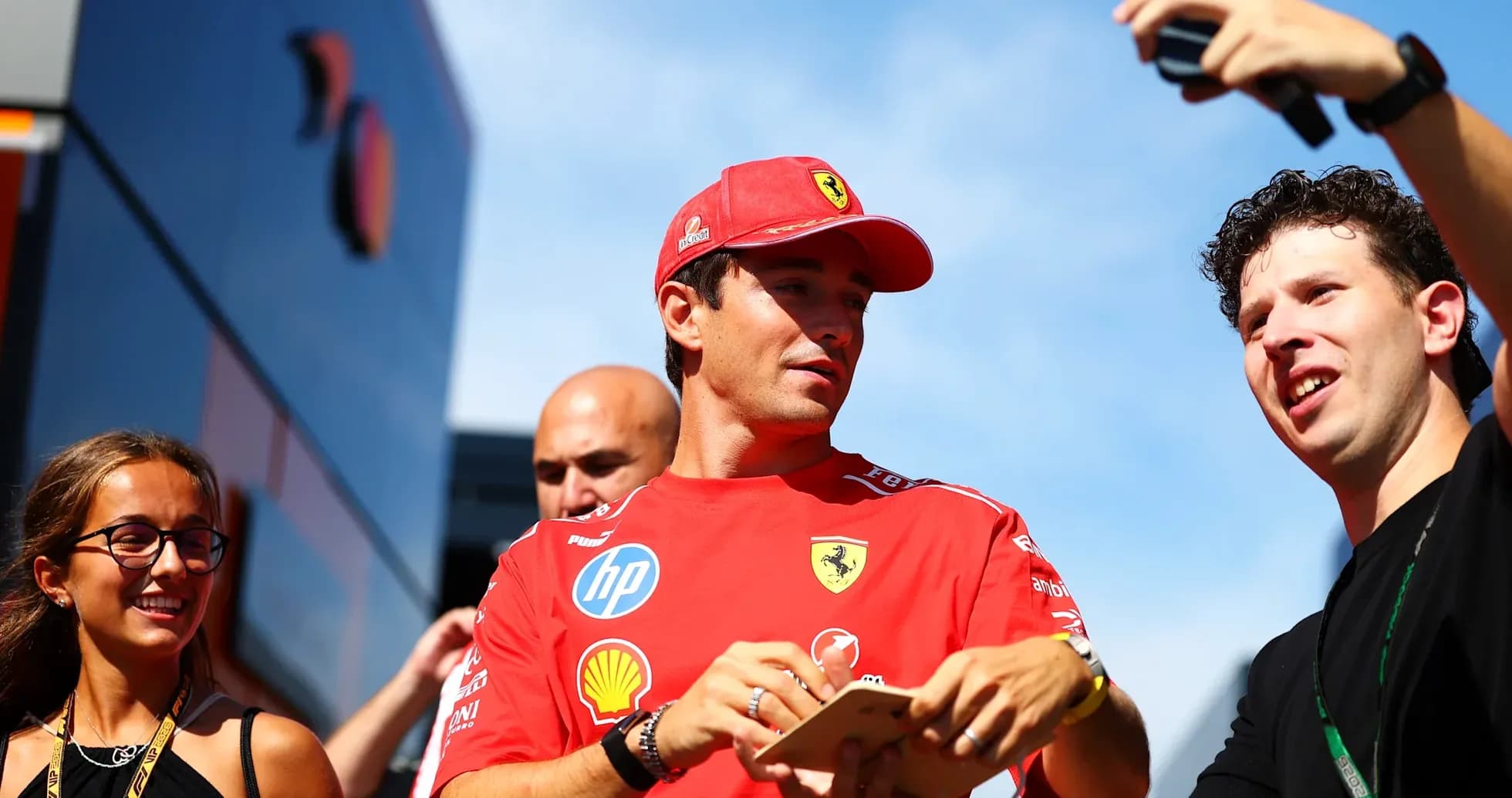 Driver in Ferrari shirt interacting with fans Driver in Ferrari shirt interacting with fans