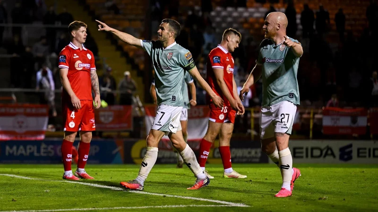 Players celebrating after scoring during a match Players celebrating after scoring during a match