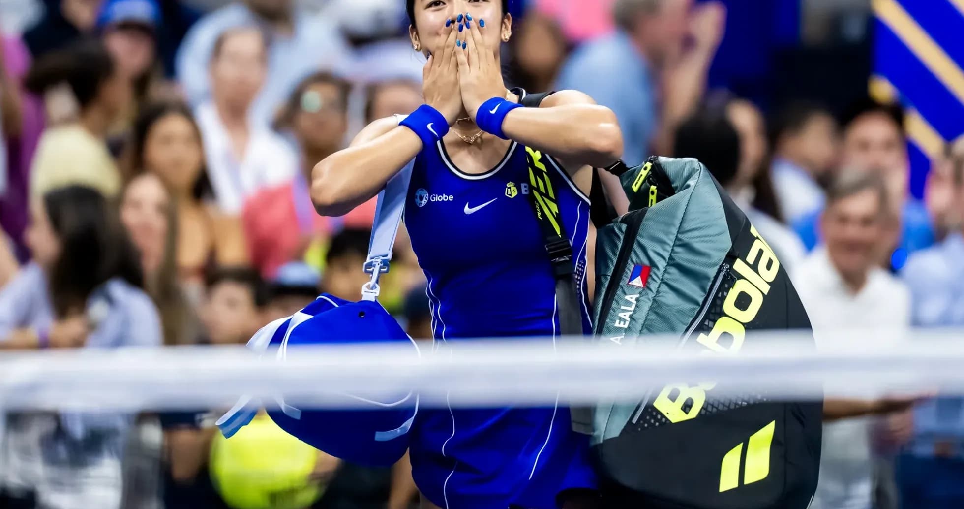 Tennis player celebrating with bags after match Tennis player celebrating with bags after match
