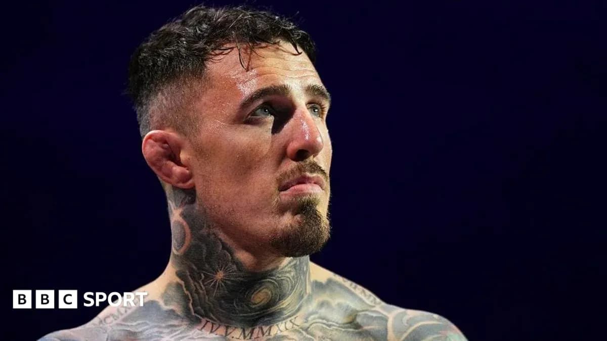 Tattooed fighter looking up in arena Tattooed fighter looking up in arena