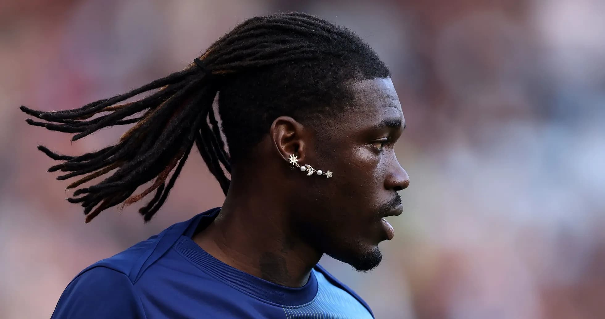 Player with long hair and unique earring profile Player with long hair and unique earring profile