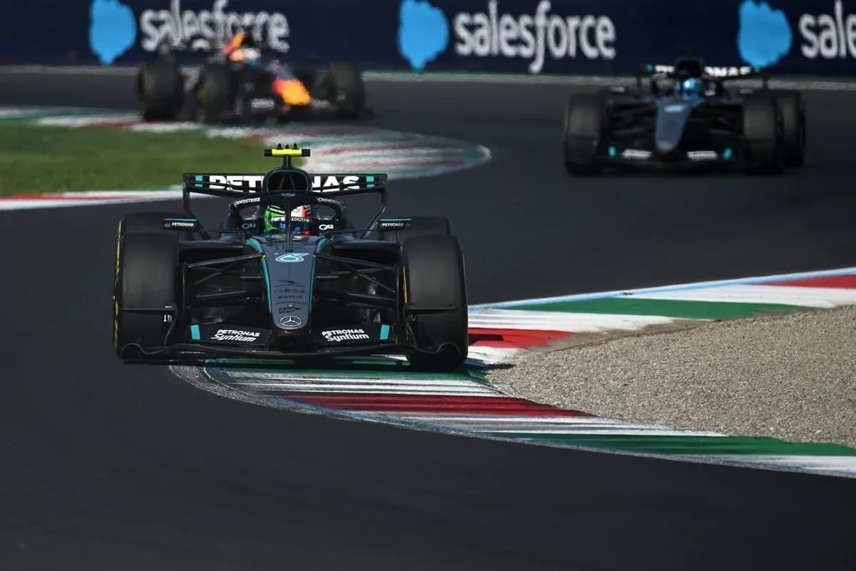 Mercedes car navigating a turn during a race Mercedes car navigating a turn during a race