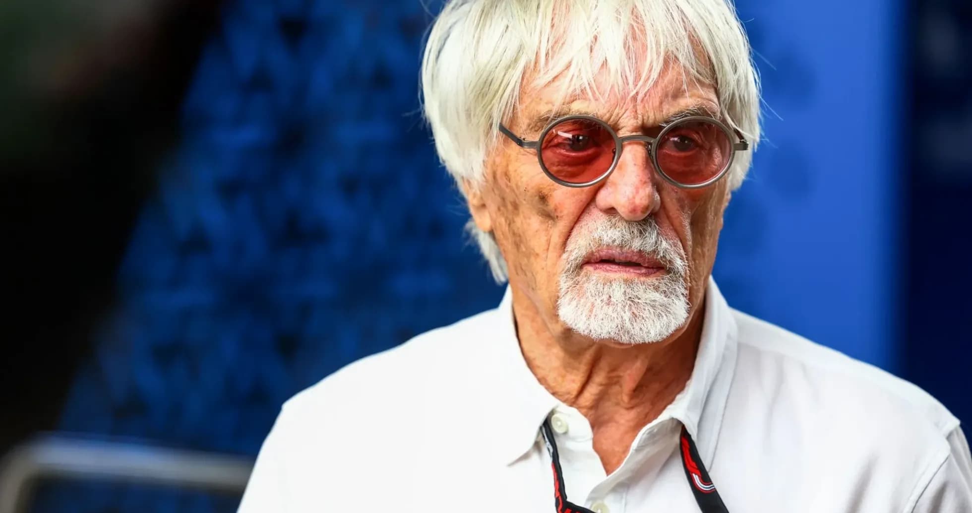 Man with white hair and sunglasses at event Man with white hair and sunglasses at event