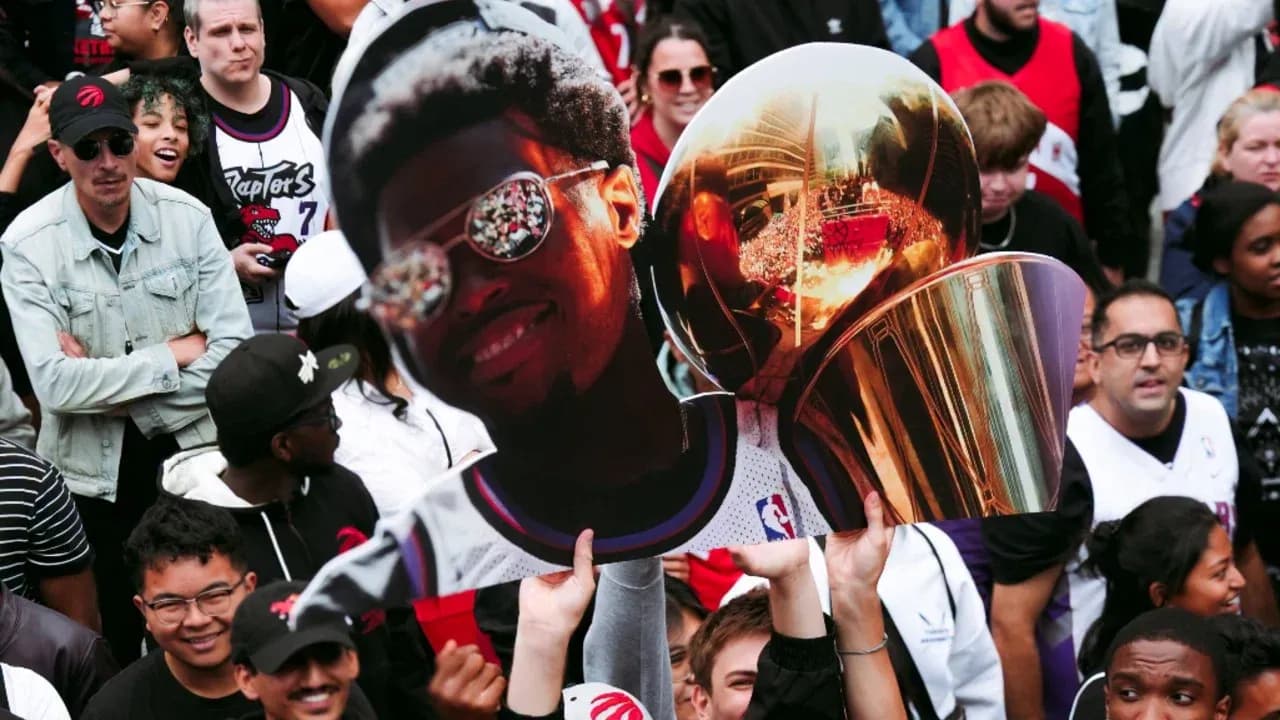 Fans holding a large cutout and trophy celebration Fans holding a large cutout and trophy celebration