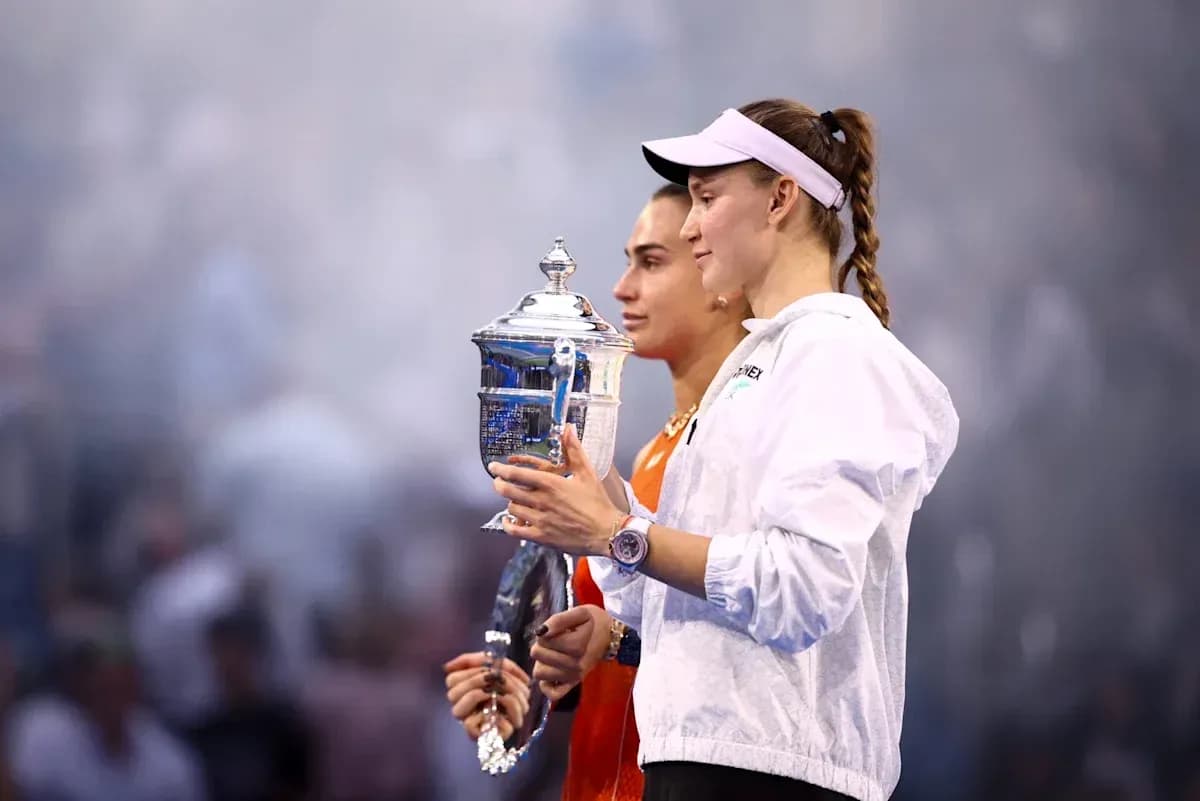 Two tennis players holding trophy after match Two tennis players holding trophy after match